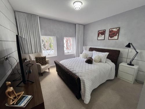 a bedroom with a bed with a cat laying on it at Center Suiço Flats in Campos do Jordão