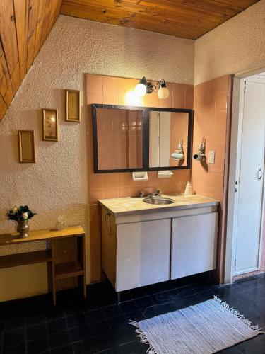 a bathroom with a sink and a mirror at Casa en Potrerillos in Potrerillos