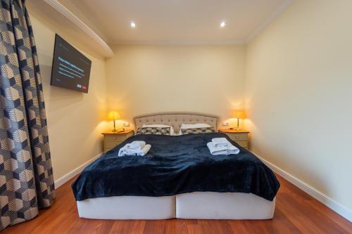 a bedroom with a bed with two towels on it at Willowa 21 in Wisła