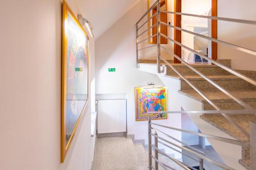 a staircase in a house with a painting on the wall at Willowa 21 in Wisła