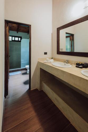 a bathroom with two sinks and a large mirror at Tierra Guaraní Lodge in Puerto Iguazú