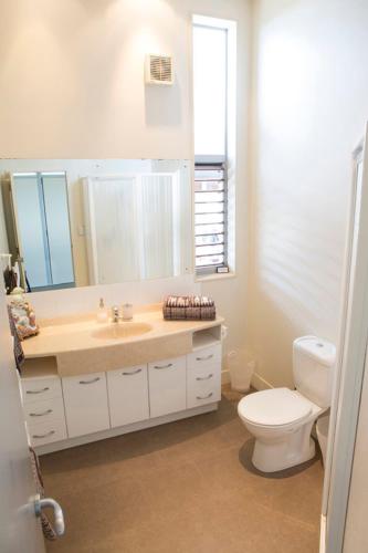 a bathroom with a sink and a toilet at View43 Beach House in Waiheke Island