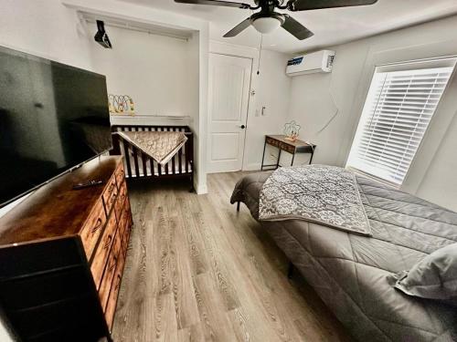 a bedroom with a large bed and a flat screen tv at #1 - 5BR 1BA - Unit A - Private Entire Home - WiFi in Midland