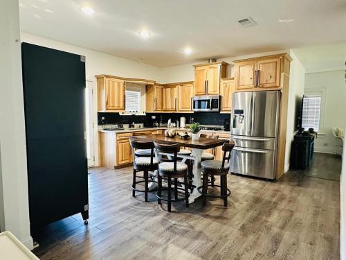 a kitchen with a table and chairs and a refrigerator at #1 - 5BR 1BA - Unit A - Private Entire Home - WiFi in Midland