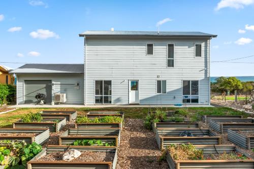 a garden in front of a house at Seven by the Sea in Kingscote