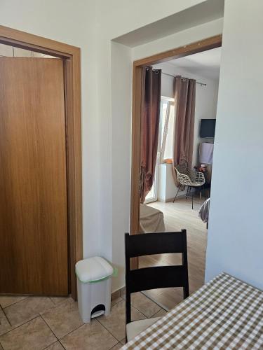 a room with a door and a table and a chair at Apartments by the sea Nevidjane, Pasman - 8453 in Neviđane