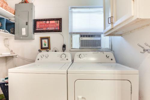 a laundry room with two sinks and a washer and dryer at Englewood Bungalow 1 Mi to Beach Pets Welcome! in Englewood