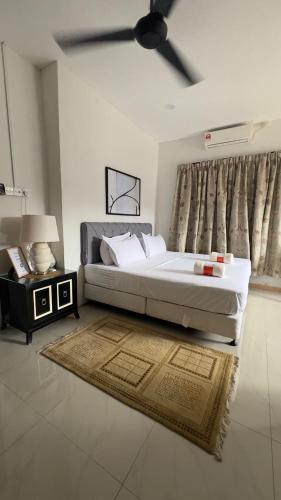 a bedroom with a large bed and a ceiling fan at Villa Alyana in Ipoh