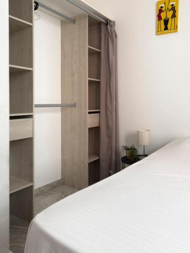 a bedroom with a white bed and a closet at Spacious 3-bdr apartment - Palmarejo Grande - LCGR in Praia