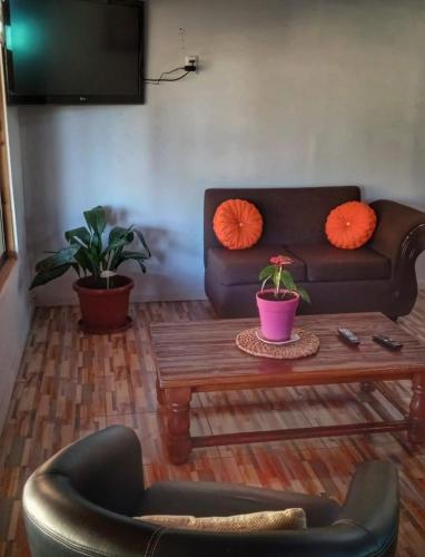 a living room with a couch and a coffee table at Parcela Pedregal in Peralillo