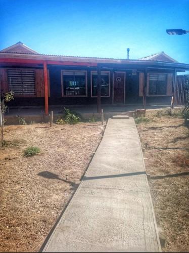 a building with a sidewalk in front of it at Parcela Pedregal in Peralillo
