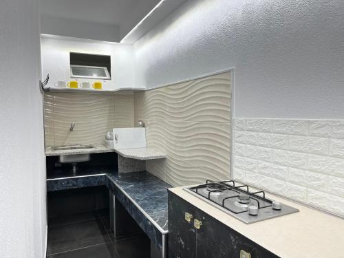 a kitchen with a stove and a sink at Villa Kasa in Durrës