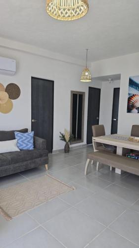 a living room with a couch and a table at Departamento en Acapulco de Juárez, Club de Playa in Acapulco