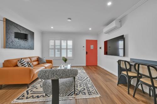 a living room with a couch and a table at The Mac in Orange