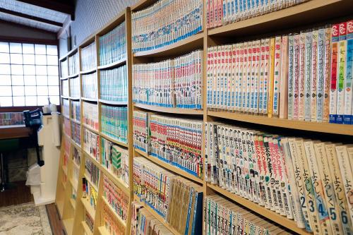 a book shelf filled with lots of books at Yanagiso in Toyooka