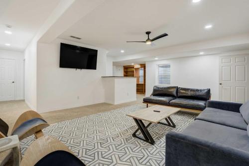 a living room with a couch and a tv on a wall at Vista Montana Downtown Monument w BBQ & Fire Pit in Monument