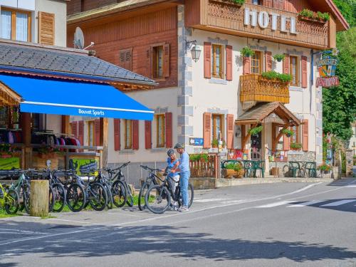 a man and a child standing next to a bike at Alpine Retreat w Sauna in Abondance