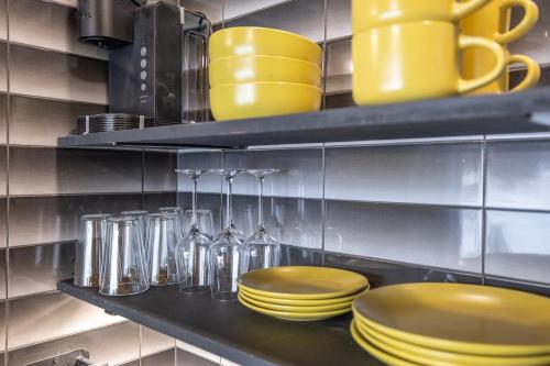 a kitchen with yellow plates and cups on a shelf at Reflection Ridge in Lead