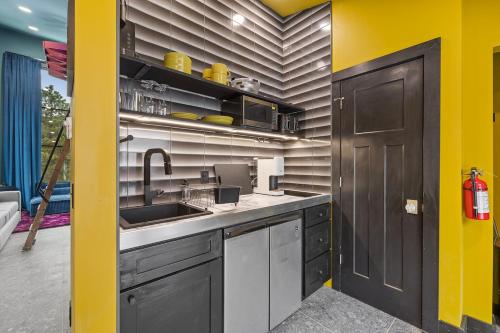 a kitchen with a sink and a yellow wall at Reflection Ridge in Lead