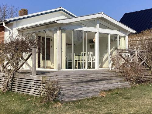 a screened in porch of a house at 4 star holiday home in SKÅNE VEJBYSTRAND in Vejbystrand