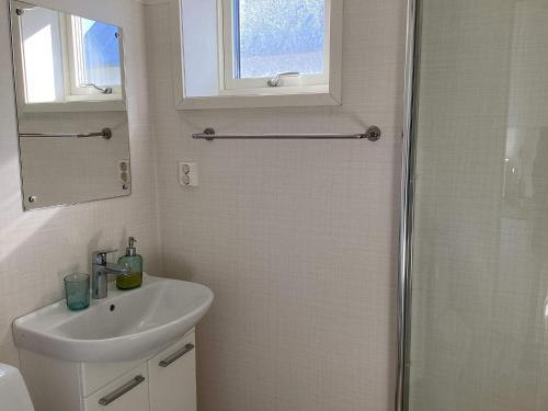 a white bathroom with a sink and a shower at 4 star holiday home in SKÅNE VEJBYSTRAND in Vejbystrand