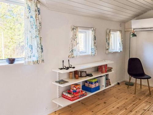 a room with white shelves and a black chair at 6 person holiday home in Thisted in Thisted