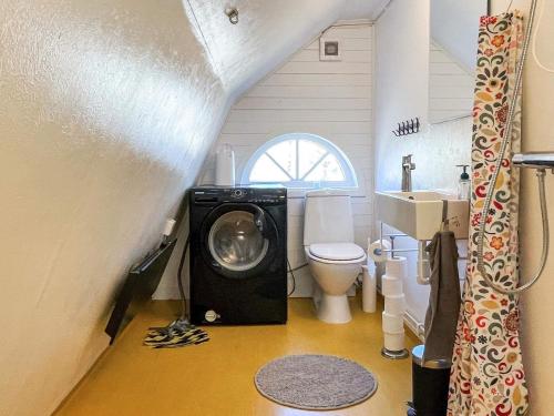 a small bathroom with a washing machine in it at 5 person holiday home in FÅRBO in Fårbo