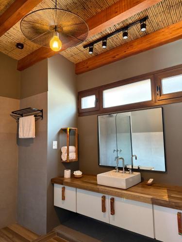 a bathroom with a sink and a mirror at Encantadora Cabaña en Purmamarca in Purmamarca