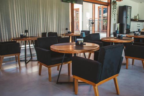 a restaurant with tables and chairs in a room at Pousada Mirante do Sol in Paraty
