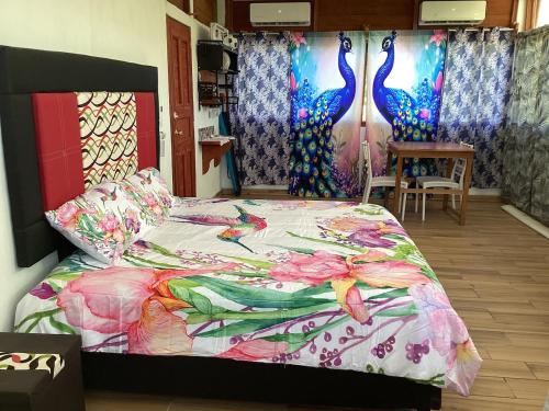 a bedroom with a bed with a colorful comforter at Vientos de magia in La Esperanza