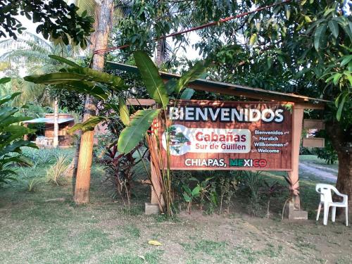 a sign in front of a tree with a sign at Vientos de magia in La Esperanza