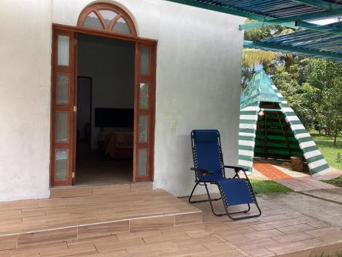 a blue chair sitting on a porch with a slide at Vientos de magia in La Esperanza