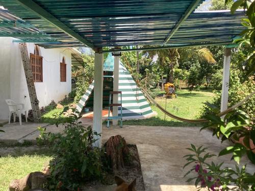 a staircase leading up to a house with a blue roof at Vientos de magia in La Esperanza