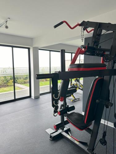 a gym with cardio equipment in a room with windows at Modern 2Br Apt Fully Furnished Barranco in Lima
