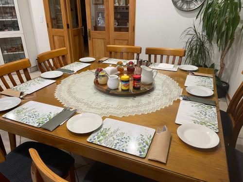 a wooden table with plates and food on it at Amberlea B&B in Hokitika