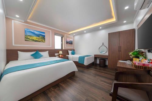 a bedroom with a large bed and a desk at Airport Classic Hotel 2 in Sóc Sơn