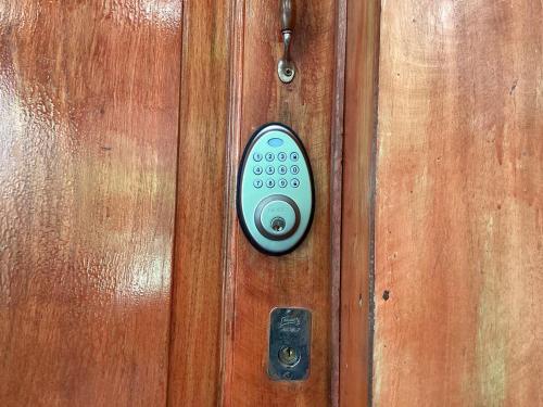 a door with a remote control on a wooden door at Exotic flower cabin pool in La Esperanza