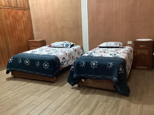 two beds sitting next to each other in a room at Exotic flower cabin pool in La Esperanza