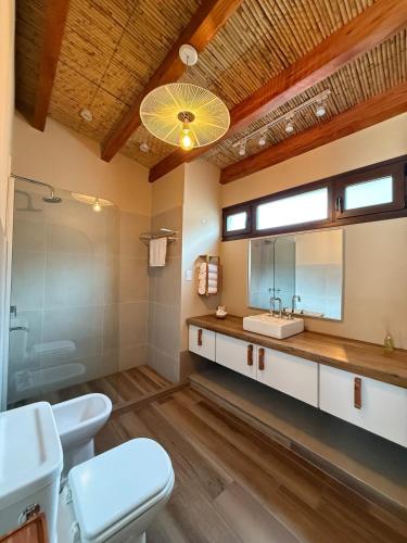 a bathroom with two toilets and a sink at Distinguida Cabaña en Purmamarca in Purmamarca