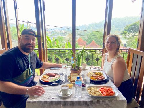 a man and a woman sitting at a table with food at Sesatha lake Kandy in Kandy