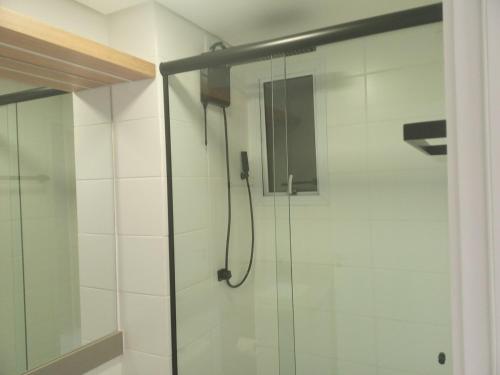 a bathroom with a shower with a glass door at Apartamento SOHO - perto da WEG in Jaraguá do Sul