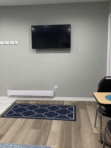 a living room with a flat screen tv on a wall at 2BR House - Quiet Getaway in Windsor