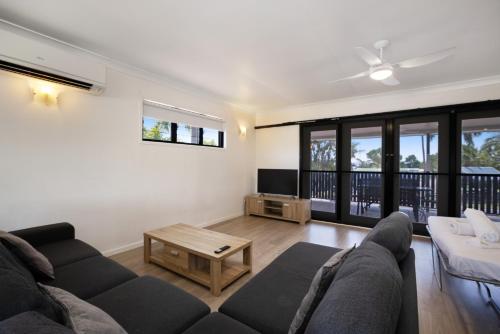 a living room with a couch and a table at Townsville Lakes Holiday Park in Townsville