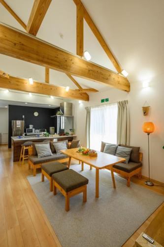 a living room with a table and a couch at 心邸 kukuru in Nakijin