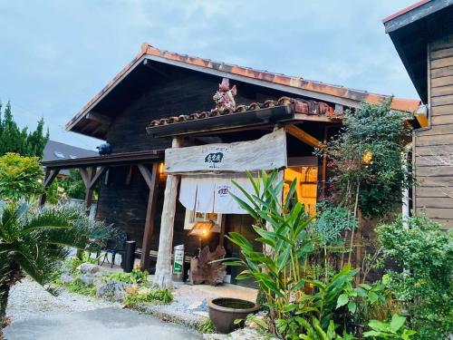 a person sitting on the roof of a house at 心邸 kukuru in Nakijin