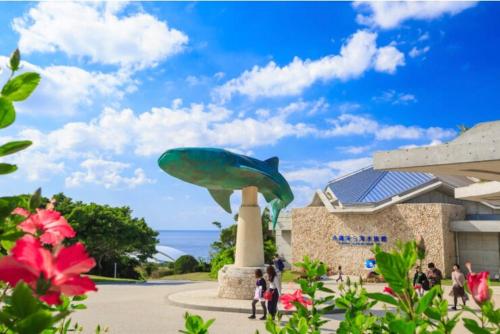 a dolphin statue in front of a building at 心邸 kukuru in Nakijin