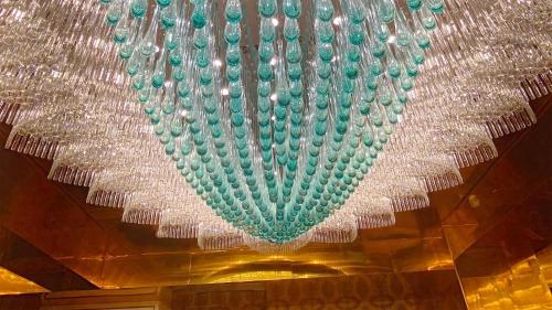 a large glass chandelier hanging from a ceiling at ホテル　ロモサ in Minakami