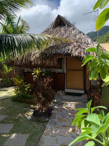 a small house with a thatched roof at FARE TEMANEA in Papetoai