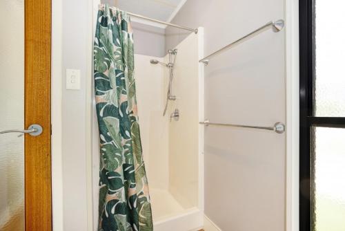 a bathroom with a shower with a shower curtain at Townsville Lakes Holiday Park in Townsville