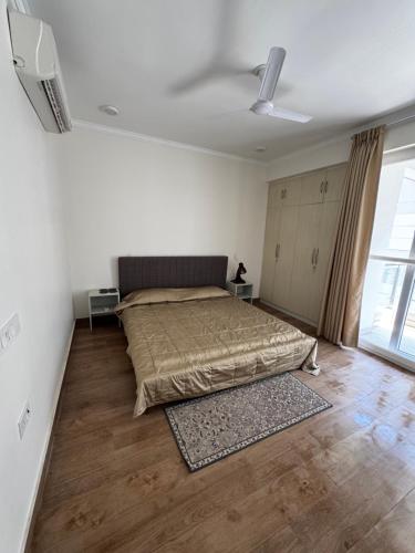 a bedroom with a bed and a large window at Poonam apartments 2 in Prayagraj